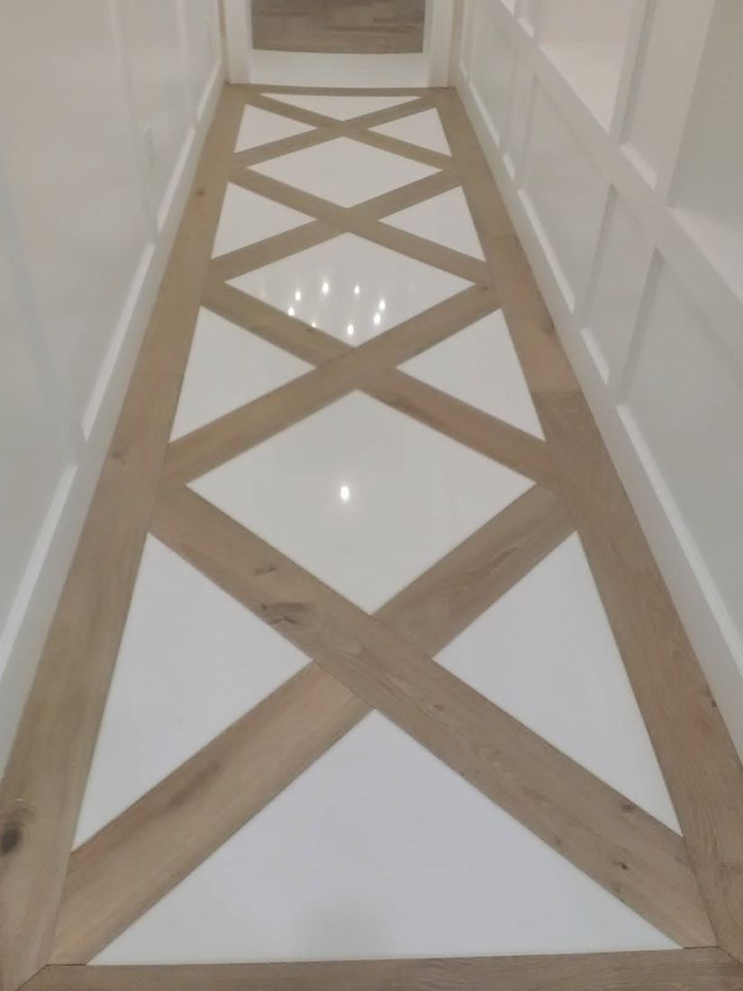 Hallway with white tile and a crossing wood-look tile inlay