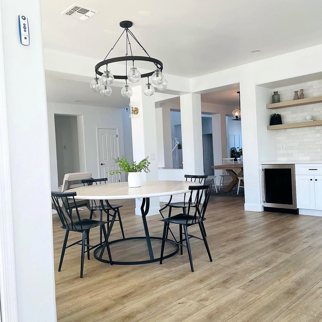 Luxury vinyl plank through an open dining room and kitchen
