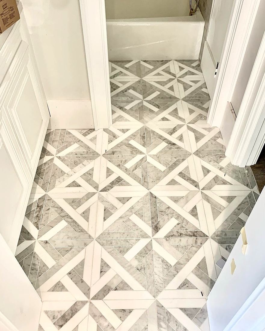 Gray and white marble pinwheel pattern bathroom floor